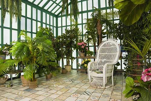 orangerie with a white chair and flowers